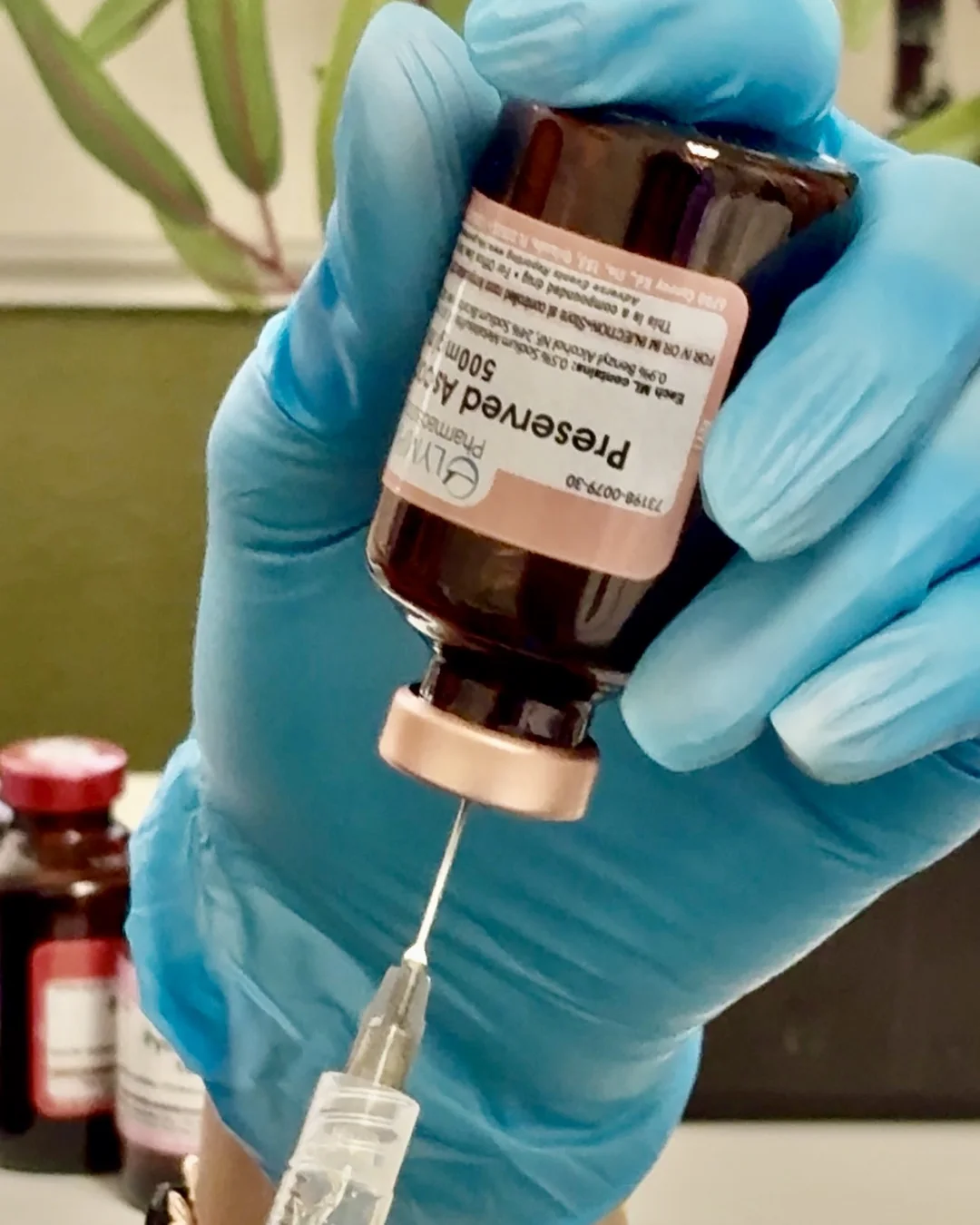 Drawing a vitamin injection from a vial at Bambu Recovery
